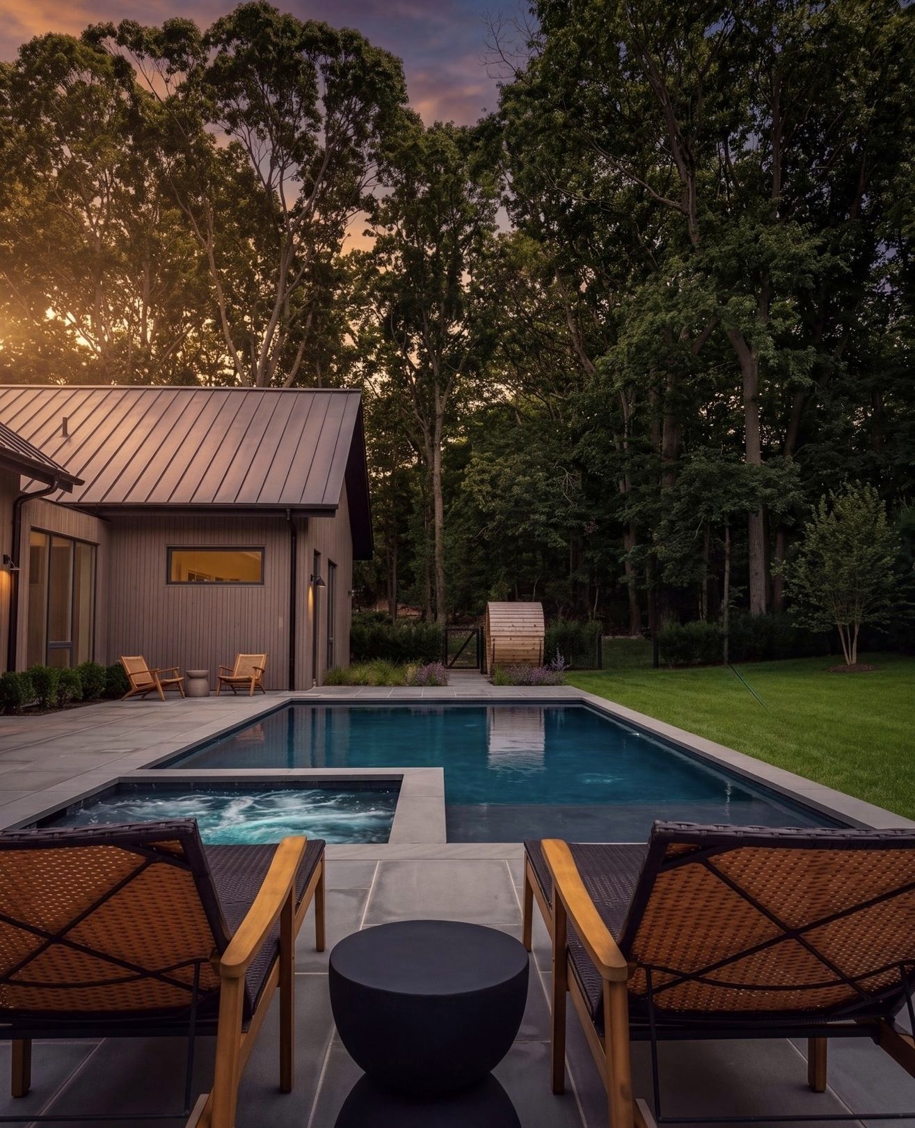 The house, terrace, pool and lawn in one daylight view