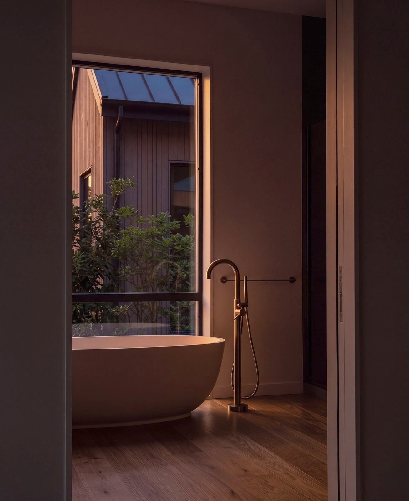 The freestanding bath seen through the doorway