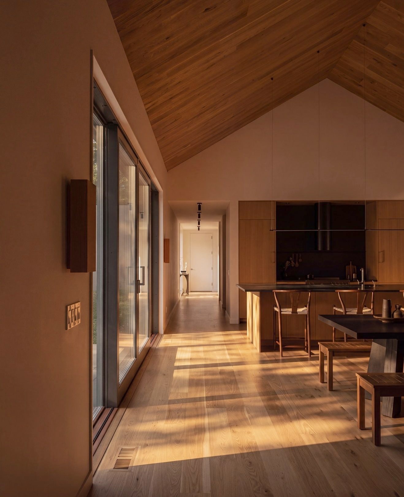 The dining table set by the glazed wall at dusk